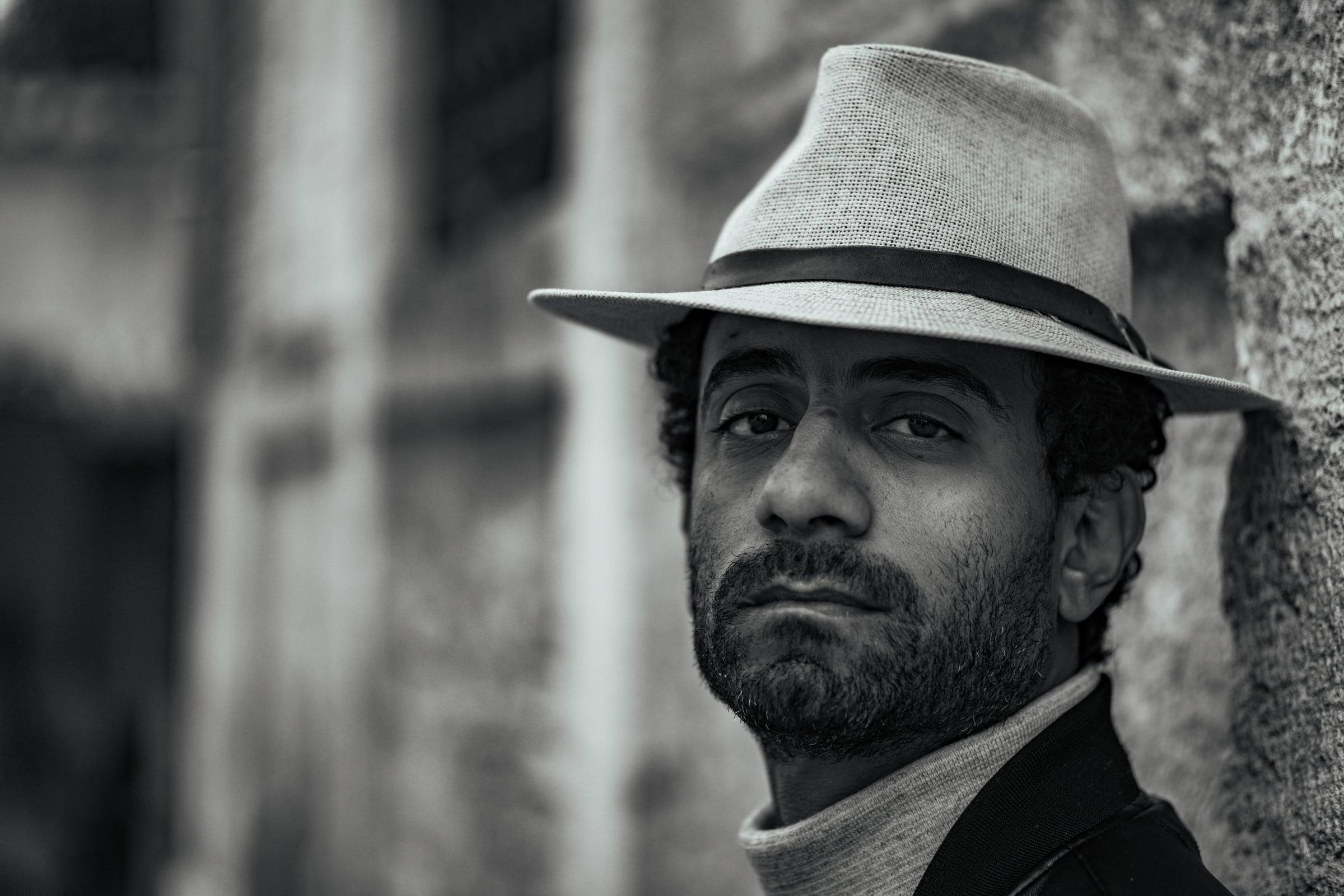 Black-and-white portrait of a man in a hat