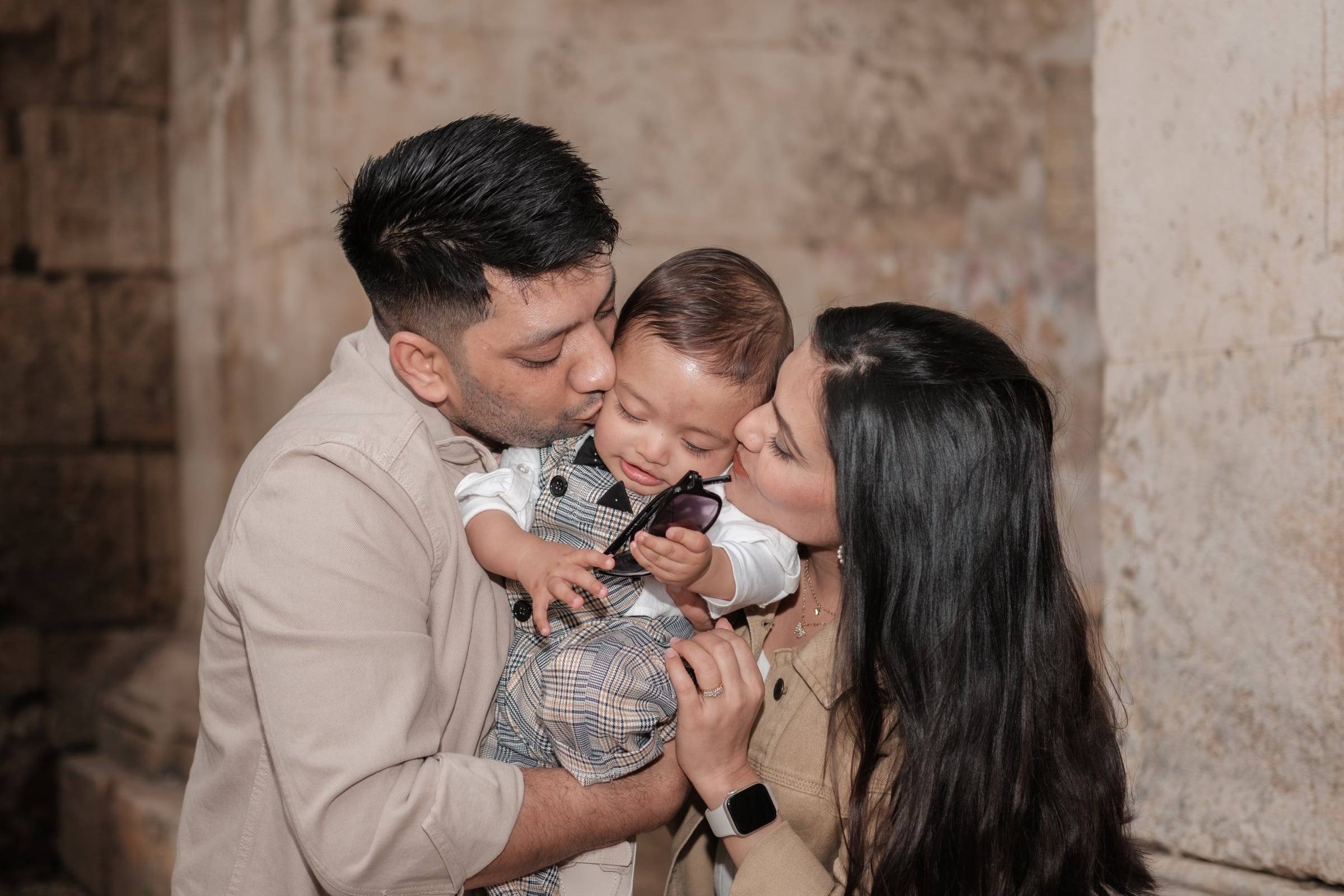 Parents kissing their baby son at Hadrian's Gate