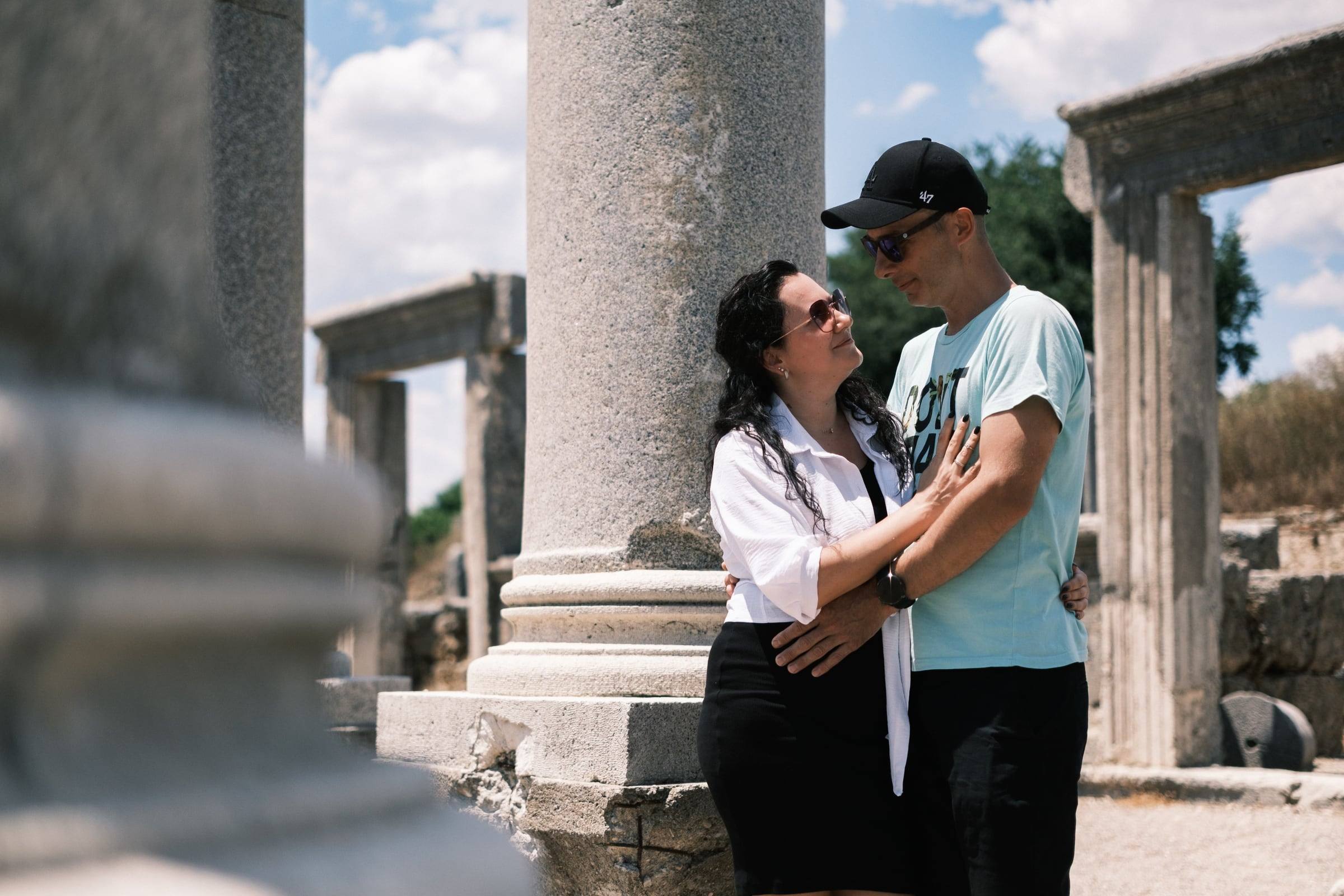 Couple embracing among the ancient columns of Perge