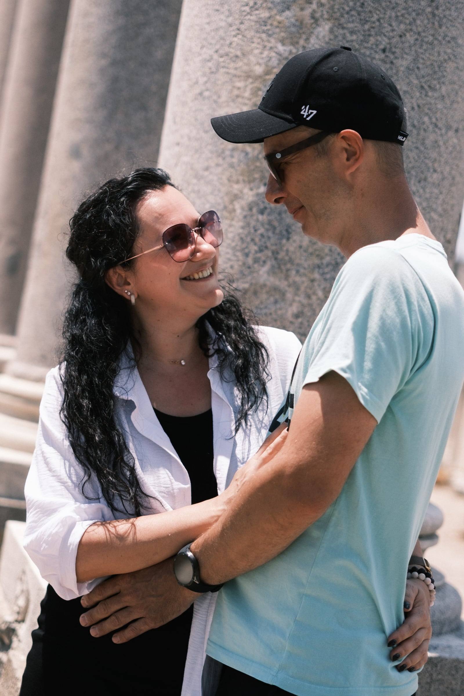 Couple smiling at each other by a Roman column in Perge