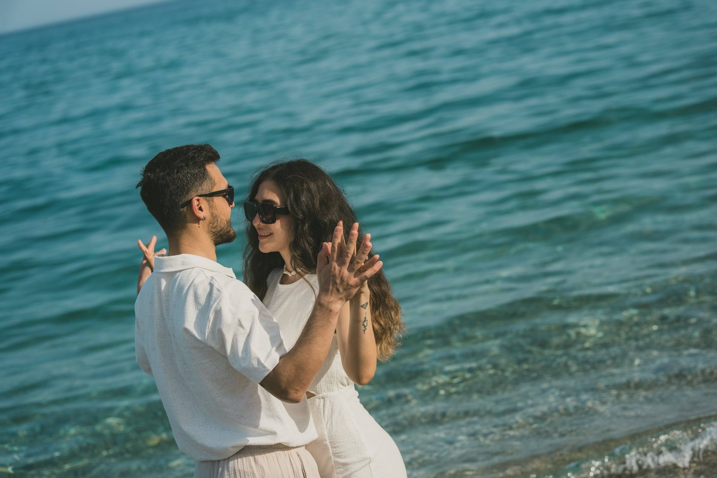 Couple in white embracing in the turquoise water