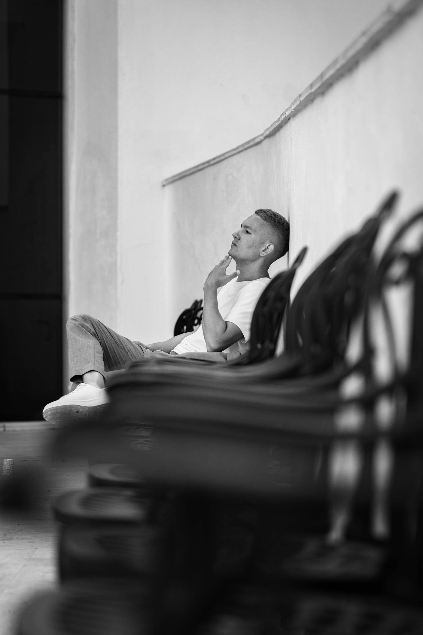 Black-and-white portrait of a man relaxing in a lounge chair
