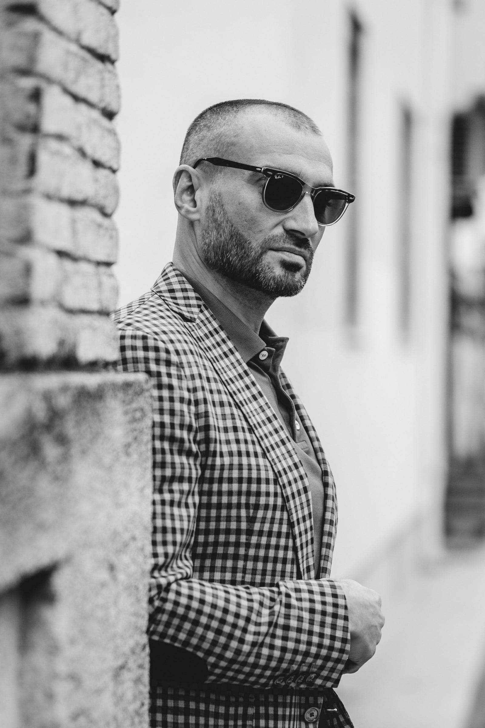 Black-and-white portrait of a man in a checked jacket